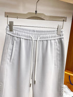 Side‑Embossed Letter Snap‑Detail Pants